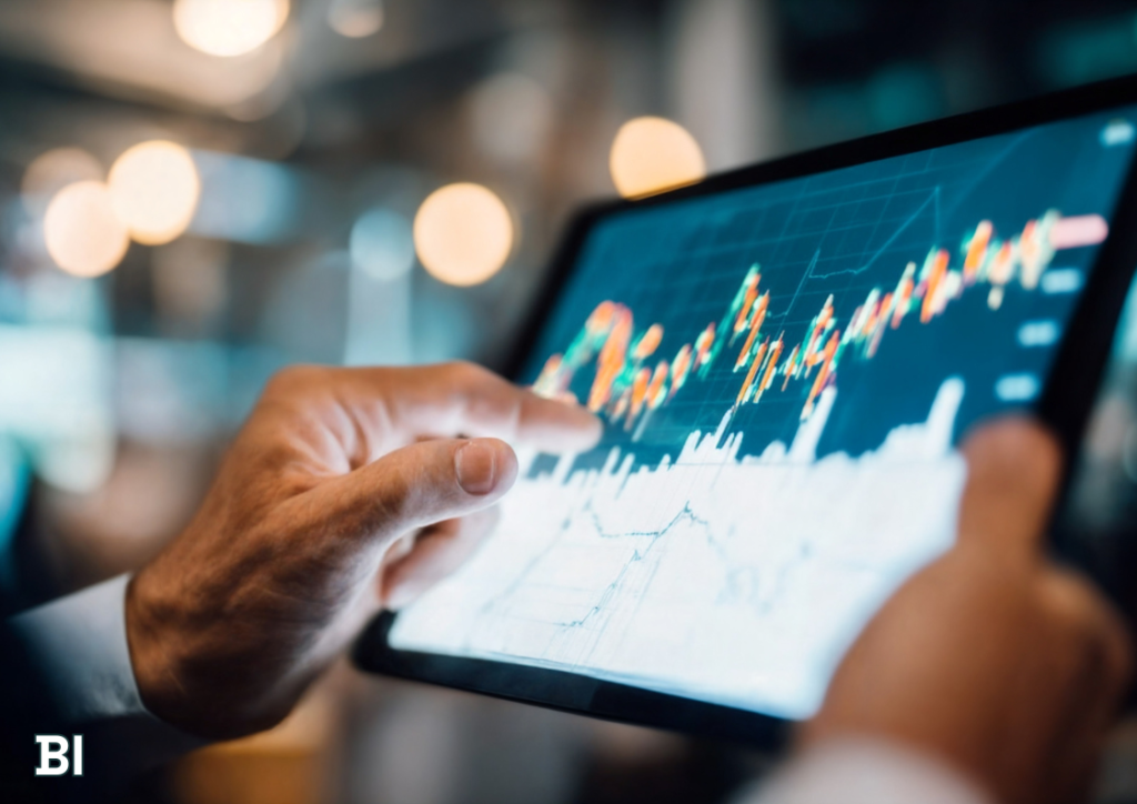 Manager monitoring real-time supply chain analytics and operations KPIs on a tablet using a Power BI dashboard.